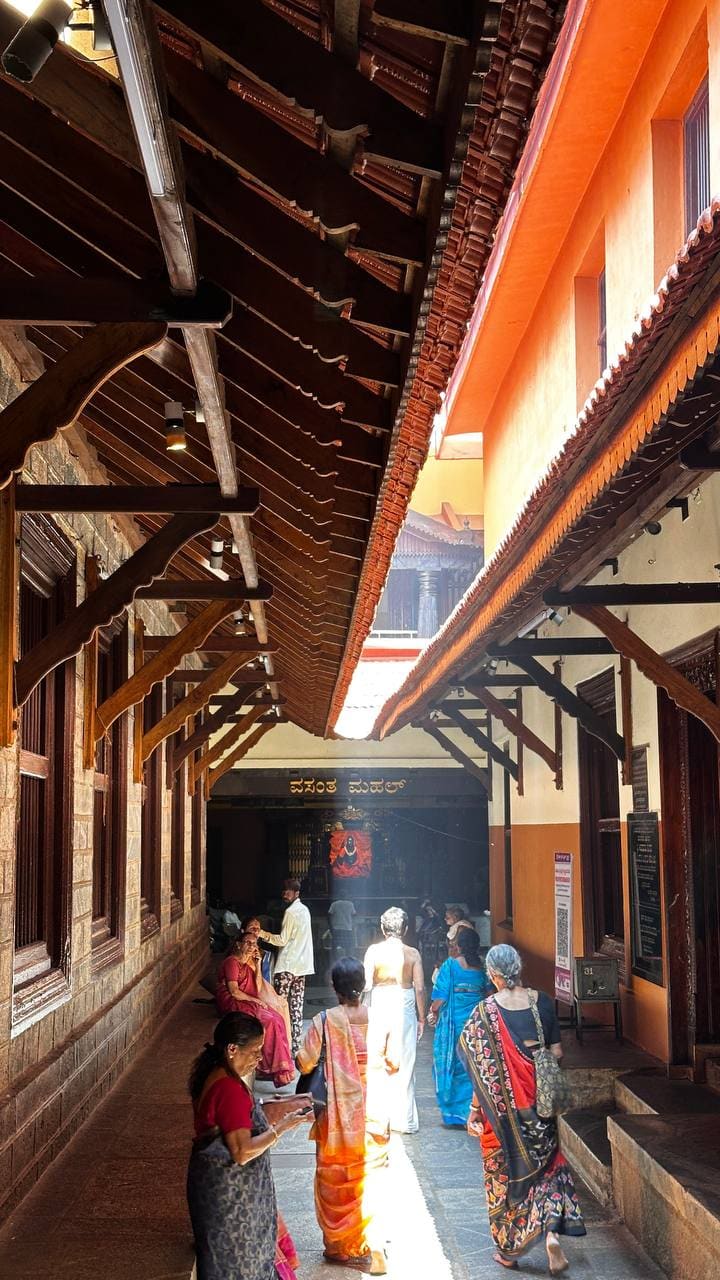 Temple corridor with devotees in colorful saris
