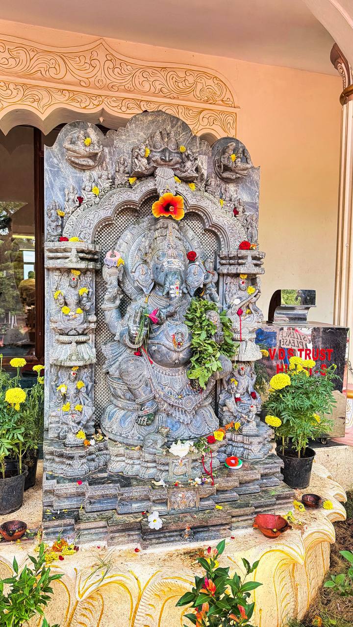 Ornate Ganesha statue with flower offerings
