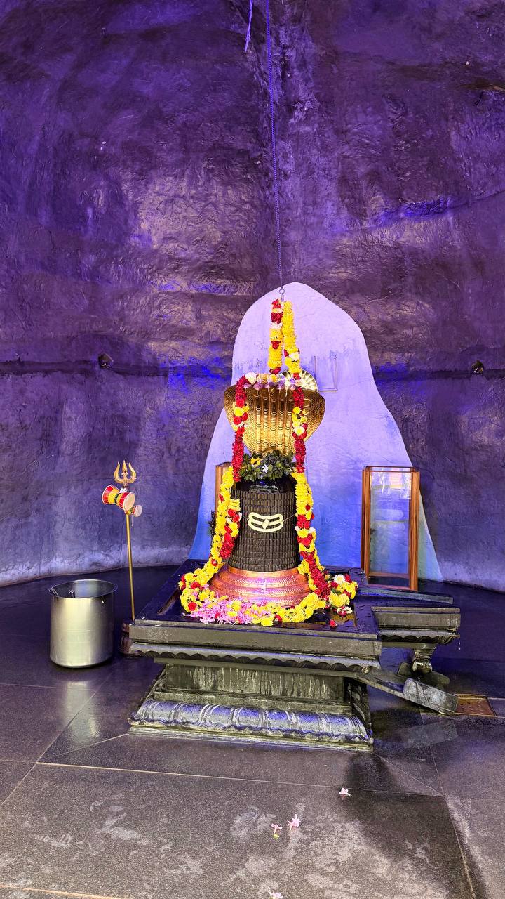 Shiva lingam with flower garlands in cave temple