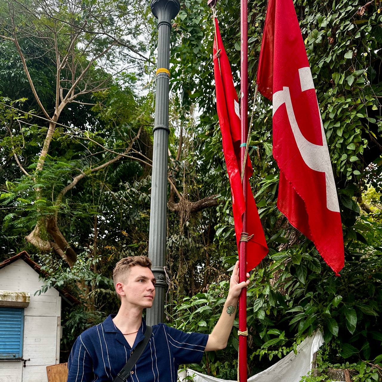 Author standing with communist red flags