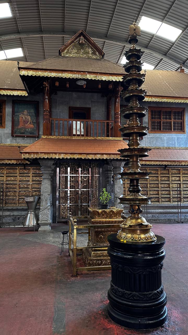 Ornate temple interior with brass lamp