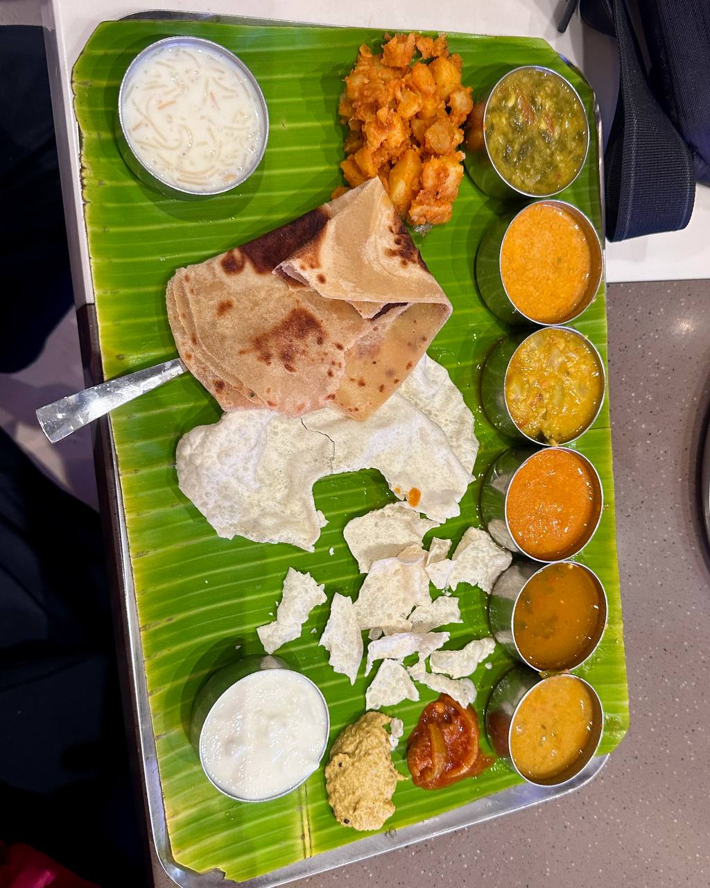 Banana leaf thali with multiple curries